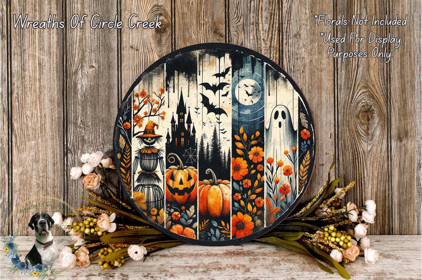 a Halloween-themed wreath with a spooky castle, bats, a full moon, a ghost, and pumpkins, all set against a wooden background. The wreath is surrounded by a floral arrangement and a small bird figurine.