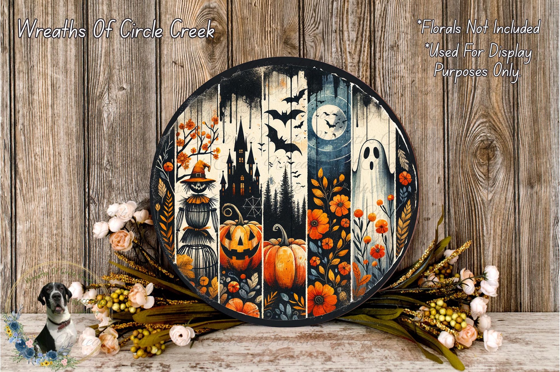 a Halloween-themed wreath with a spooky castle, bats, a full moon, a ghost, and pumpkins, all set against a wooden background. The wreath is surrounded by a floral arrangement and a small bird figurine.