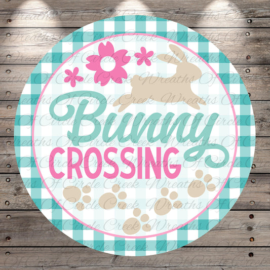 The image is a round sign with the text "Bunny Crossing" written on it, surrounded by a checkered border and a pink flower design.