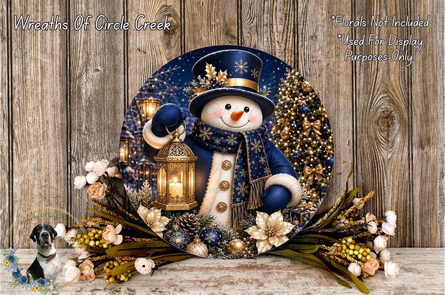 A snowman holding a lantern stands in a wreath of flowers and greenery, with a Christmas tree in the background.