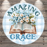 an open book with a bouquet of blue and white flowers resting on top of it, surrounded by the text "Amazing Grace".