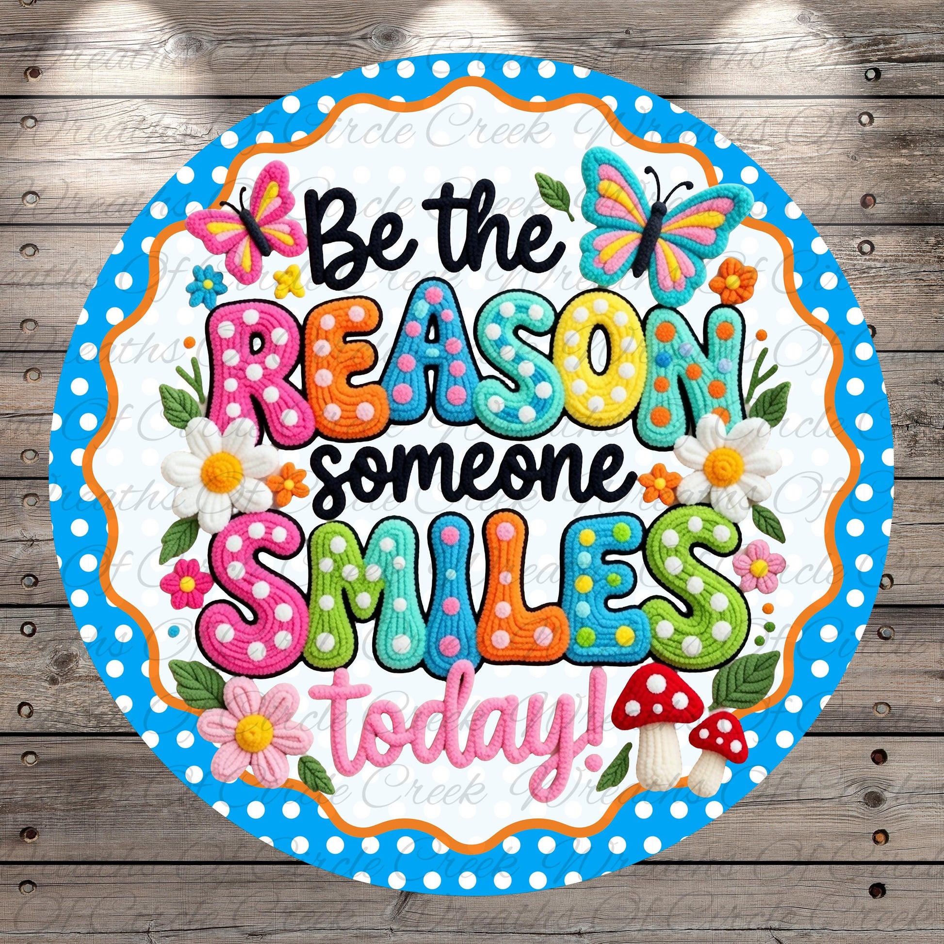 A colorful and whimsical sign with the text "Be the reason someone smiles today!" surrounded by various decorative elements such as butterflies, flowers, and mushrooms.