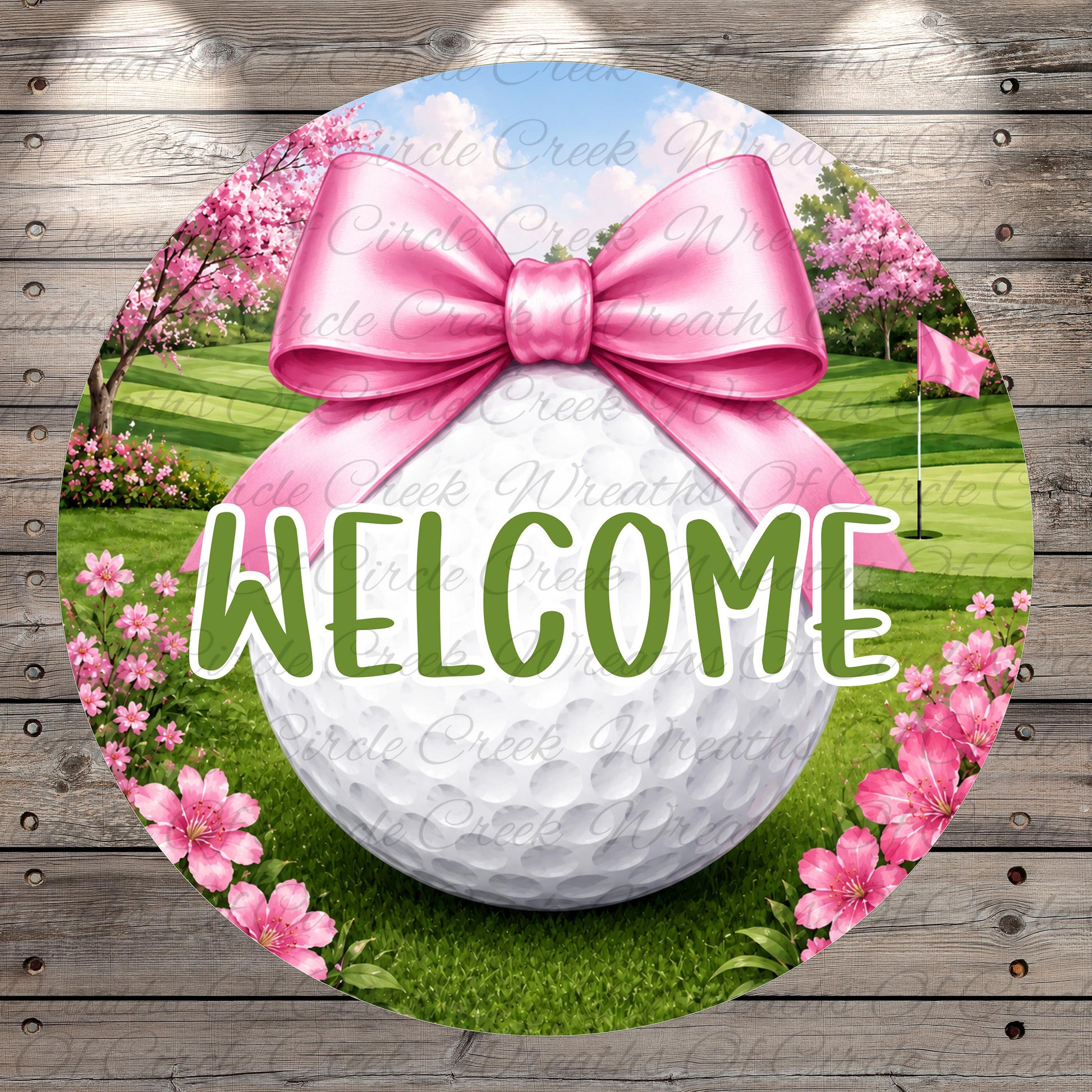 A round sign with a golf ball, pink ribbon, and pink flowers, along with the word "WELCOME" written on it.