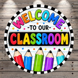 A colorful welcome sign for a classroom, featuring the text "WELCOME TO OUR CLASSROOM" surrounded by a border of colored pencils.
