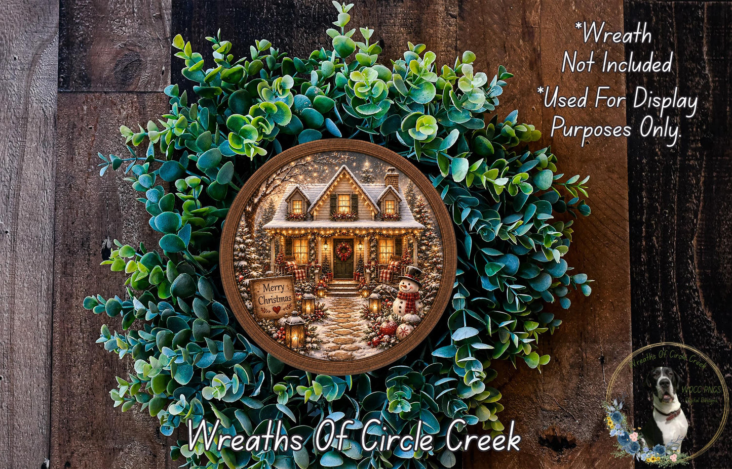 A wreath with a house and Christmas decorations, including a snowman and other festive elements, is displayed on a wooden surface.