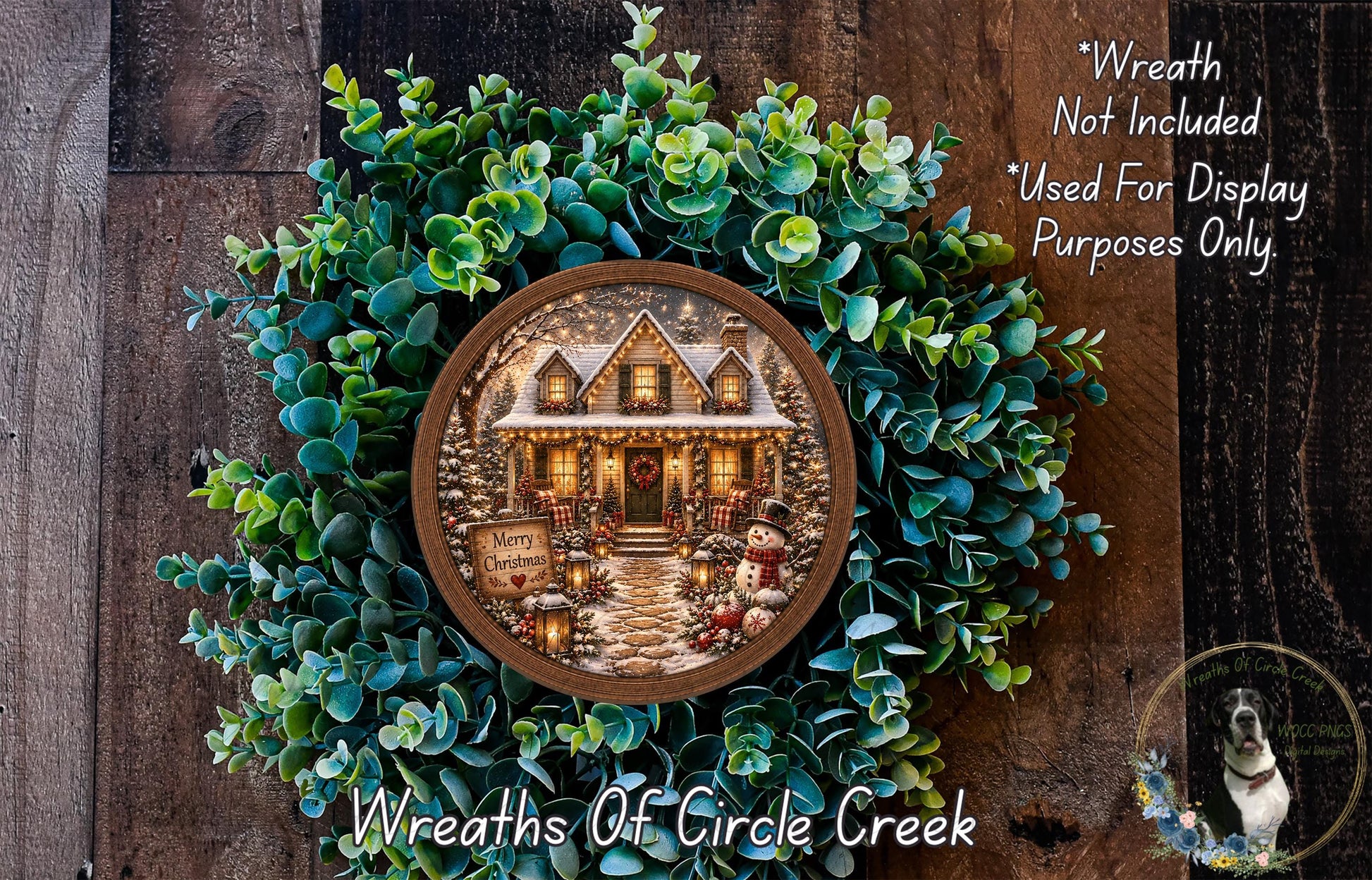 A wreath with a house and Christmas decorations, including a snowman and other festive elements, is displayed on a wooden surface.