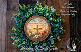 a wreath with a cross and a Bible verse, surrounded by greenery.