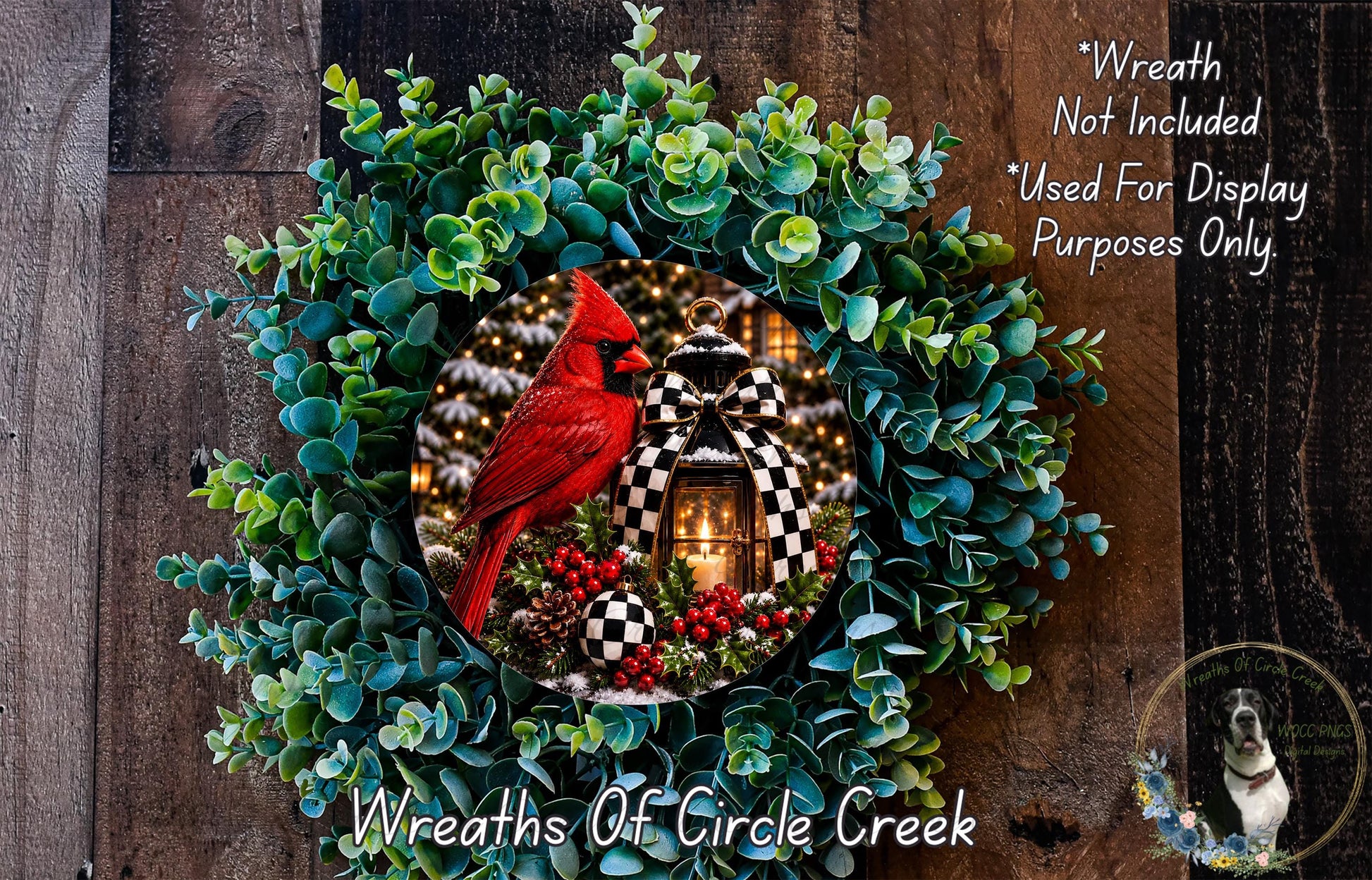 A wreath made of green leaves and red berries, with a red cardinal perched on a branch in the center. The wreath is displayed on a wooden surface, and there is a small dog in the bottom right corner.