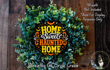 a wreath made of green leaves and flowers, with a decorative text that reads "Home Sweet Haunted Home" in orange and yellow colors.