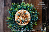 The image is a wreath made of various fall-themed elements, including sunflowers, pumpkins, and pine cones, set against a wooden background.
