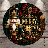 A nutcracker figure wearing a green and red outfit stands in front of a Christmas tree, with a "Merry Christmas" sign in the background.