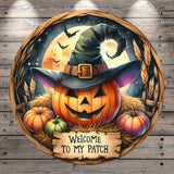 A Halloween-themed illustration featuring a jack-o-lantern wearing a witch's hat, surrounded by pumpkins, hay, and a full moon, with a "Welcome to my Patch" sign in the foreground.