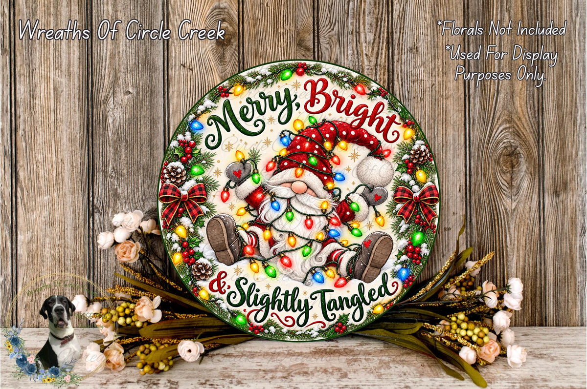 A festive holiday-themed wreath with a Santa Claus figure and Christmas lights, placed on a wooden surface.