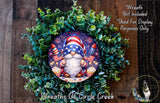 A wreath featuring a gnome holding a fireworks display, surrounded by greenery.