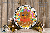 A decorative Thanksgiving wreath featuring a colorful turkey with a bow, surrounded by a floral arrangement and placed on a wooden surface.