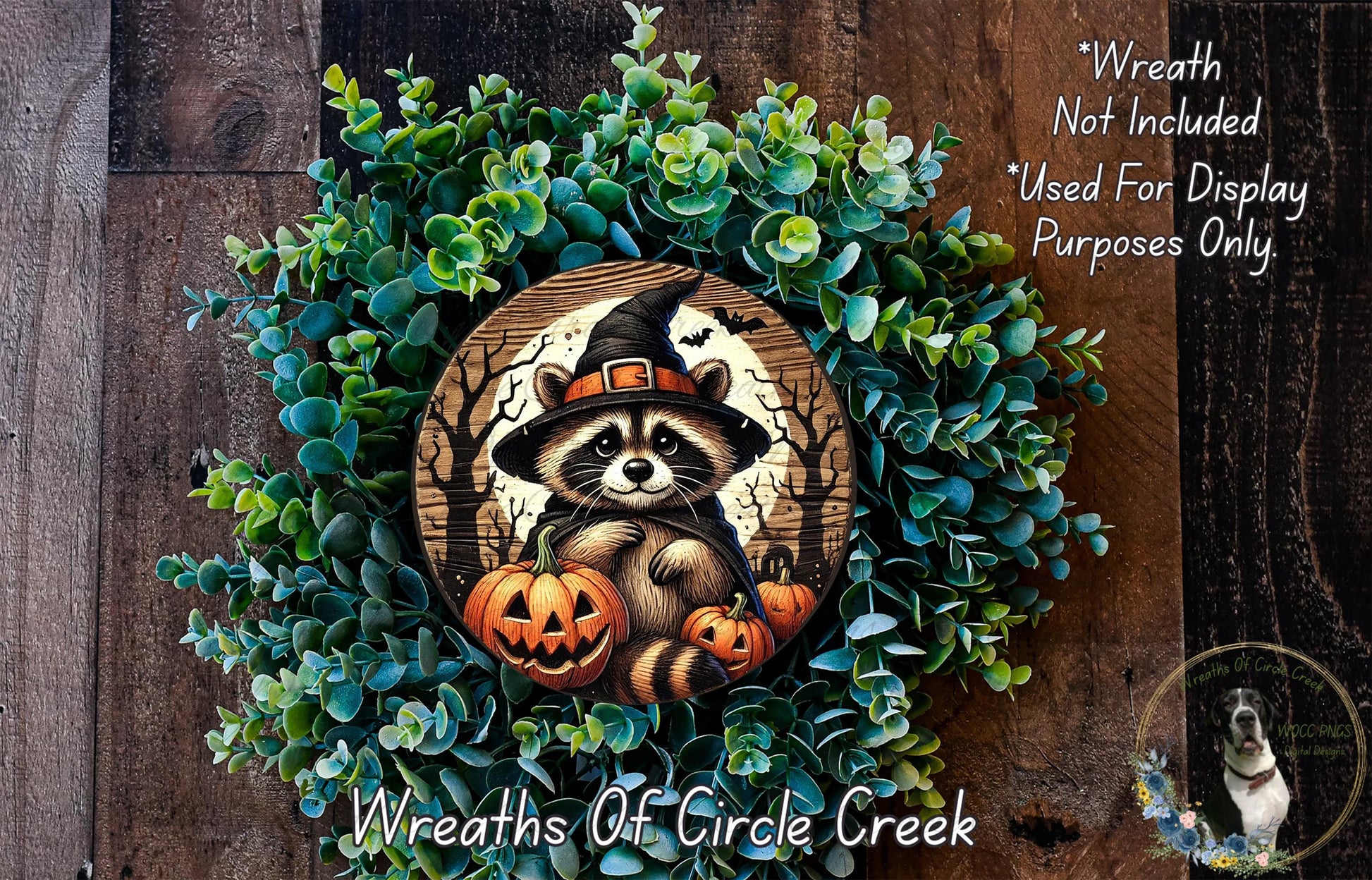 A wreath made of green plants and pumpkins, featuring a raccoon wearing a witch's hat.