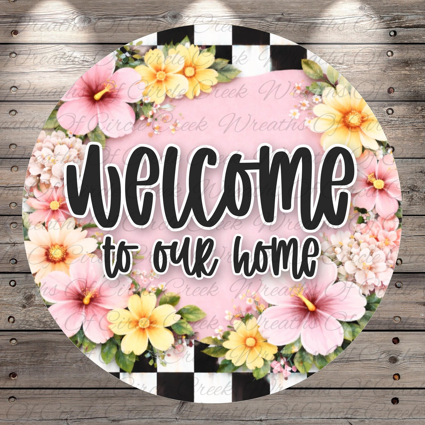 A circular sign with a floral border and the text "Welcome to our home" in bold, black letters.