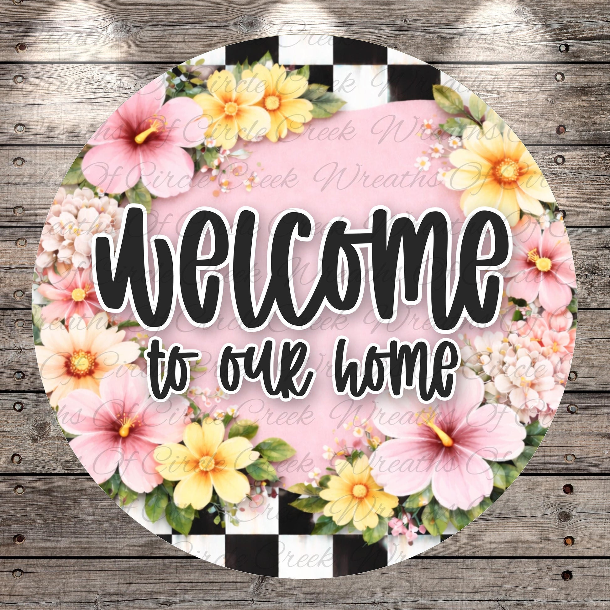 A circular sign with a floral border and the text "Welcome to our home" in bold, black letters.