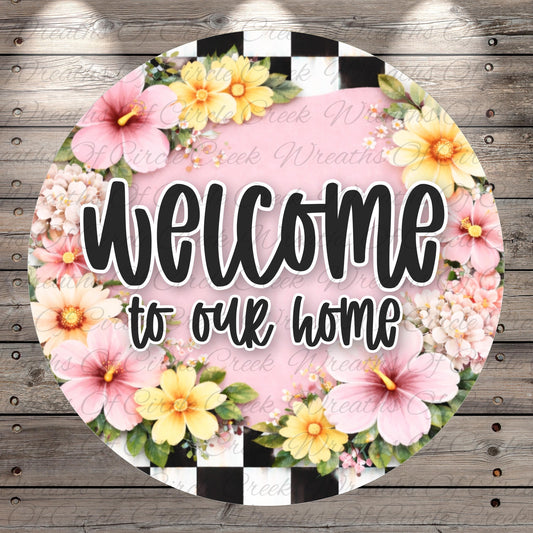 A circular sign with a floral border and the text "Welcome to our home" in bold, black letters.