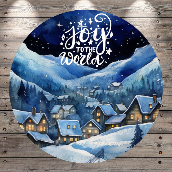 A circular illustration depicting a snowy village at night, with houses and trees illuminated by warm lights. The sky above is dark and starry, creating a serene and peaceful atmosphere. The text "Joy to the world" is written in white against the dark background, conveying a sense of warmth and happiness.
