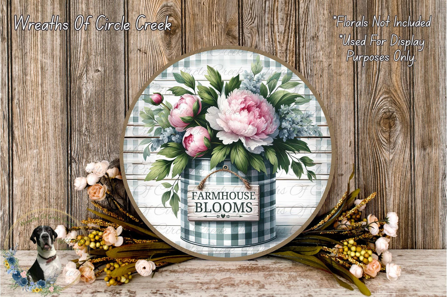 a round wooden sign with a floral design, surrounded by a variety of flowers and foliage. The sign reads "Farmhouse Blooms" and is placed on a wooden surface.