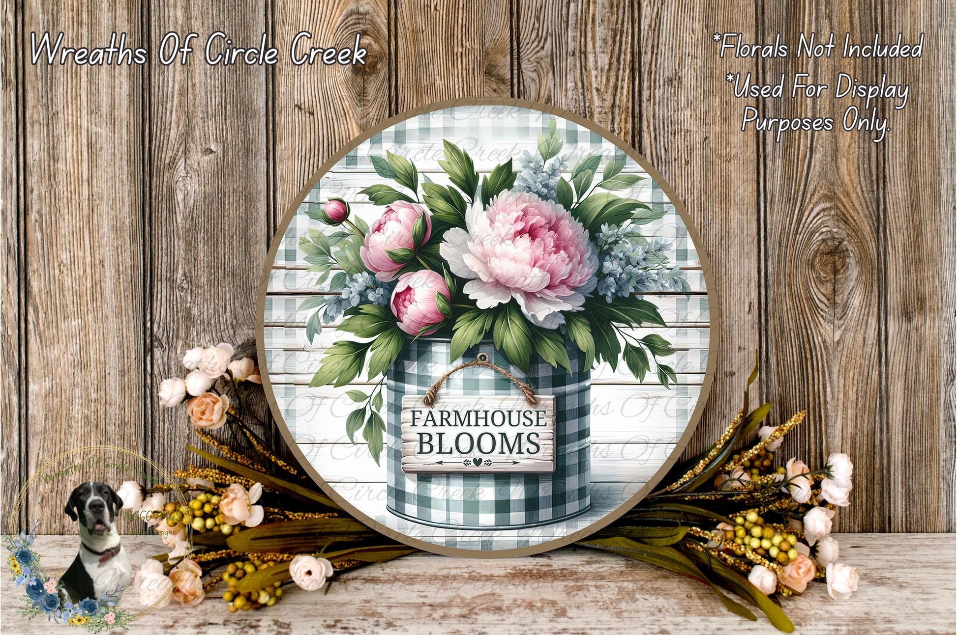 a round wooden sign with a floral design, surrounded by a variety of flowers and foliage. The sign reads "Farmhouse Blooms" and is placed on a wooden surface.