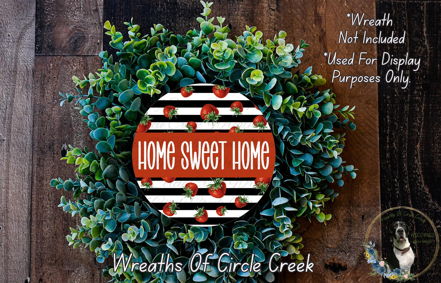 a wreath made of green and white leaves, with a red and white circular design in the center that says "Home Sweet Home".