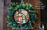 A wreath made of green leaves and featuring a snowman and a snowman on a red and white plaid scarf, with the text "SEASON to FREEZIN" and "Wreaths of Circle Creek" displayed.