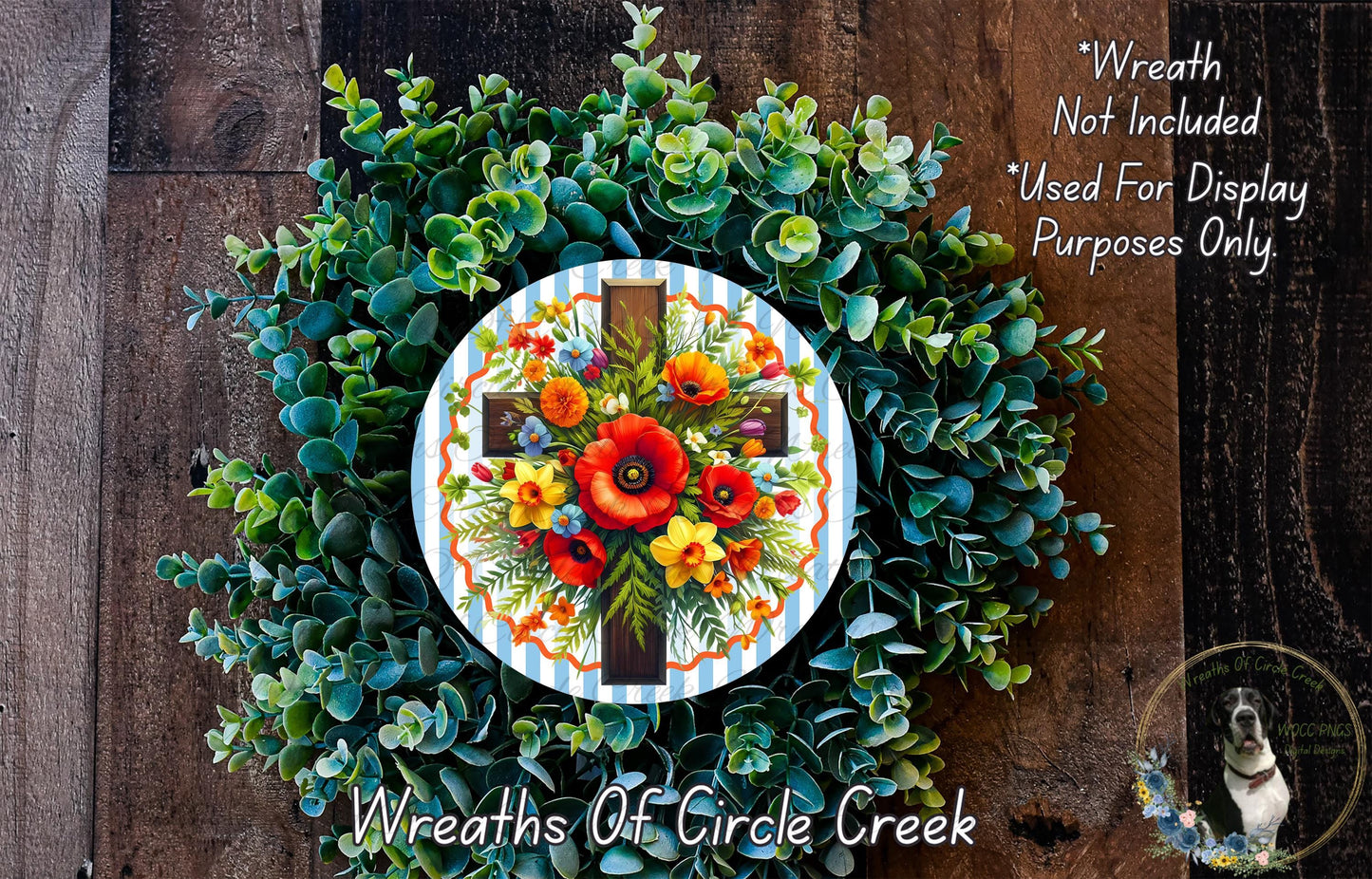 a wreath with a cross and a floral arrangement, placed on a wooden surface.
