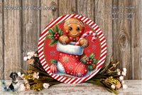 A festive Christmas wreath featuring a gingerbread man in a red stocking, surrounded by flowers and a candy cane.