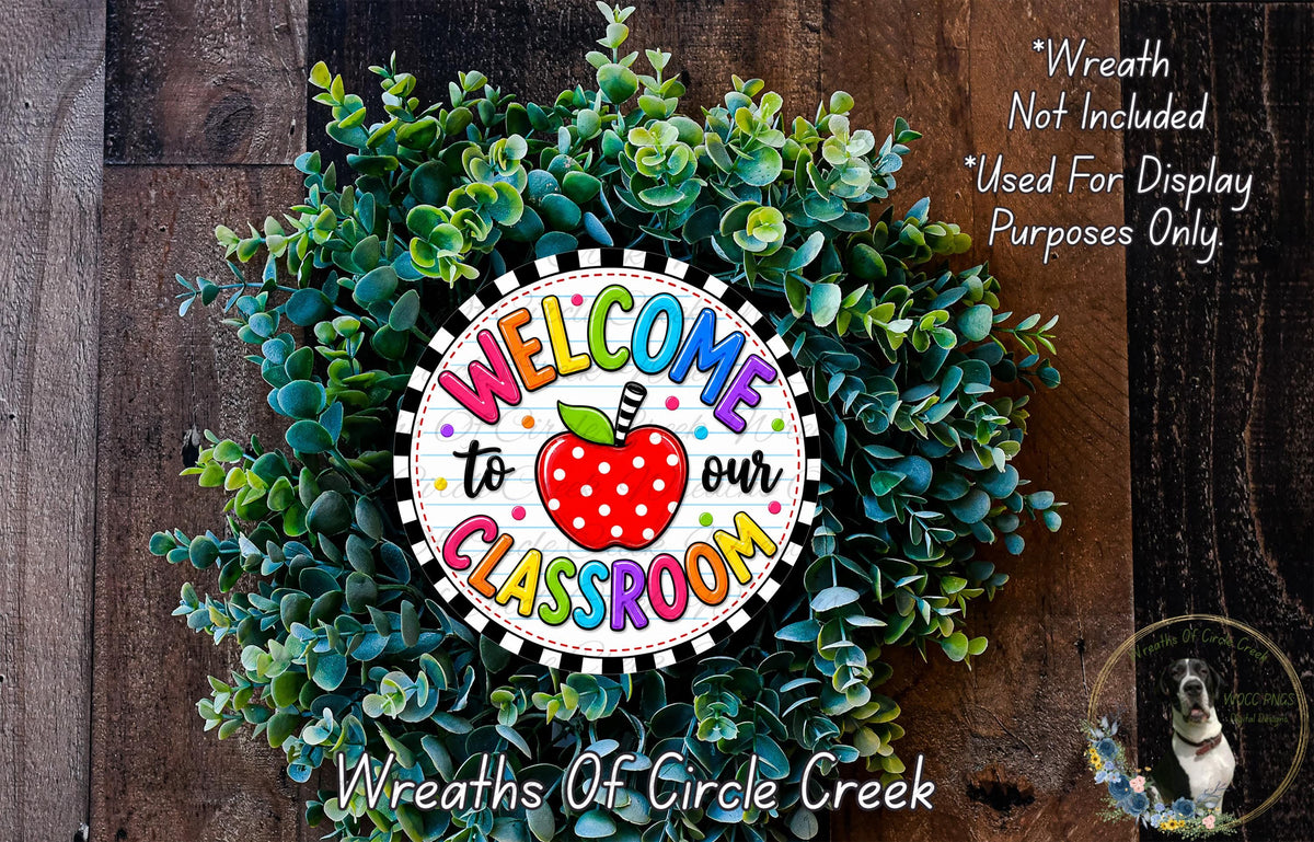 a colorful wreath made of green leaves and a red apple, with the text "Welcome to our Classroom" displayed on it.