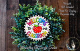 a colorful wreath made of green leaves and a red apple, with the text "Welcome to our Classroom" displayed on it.