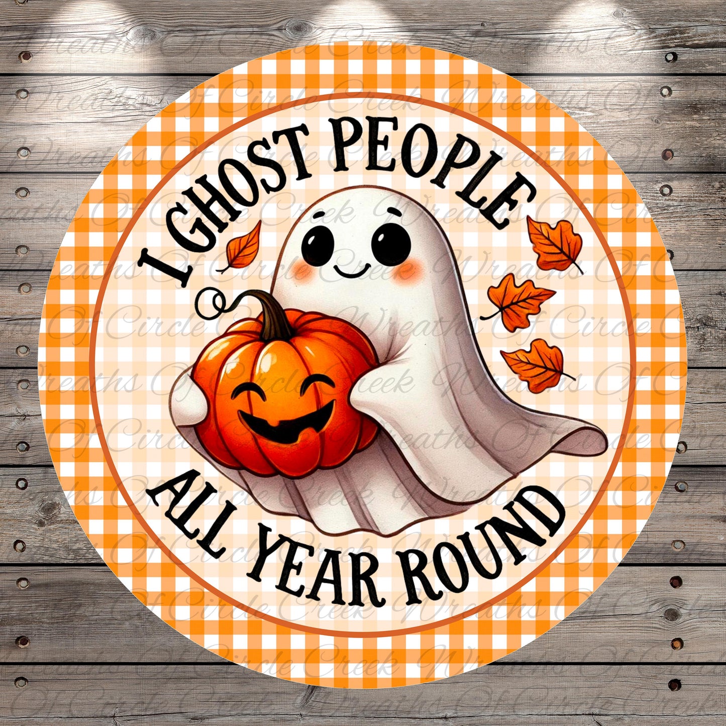 A round, orange and white sign with a cartoon ghost holding a pumpkin and the text "I ghost people all year round"