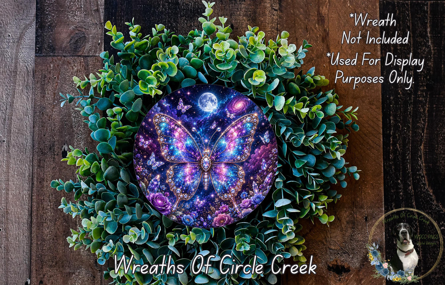 A wreath made of green leaves and flowers, with a large, colorful butterfly design in the center. The butterfly has a purple and blue pattern and appears to be floating in a starry night sky. The wreath is set against a wooden background.