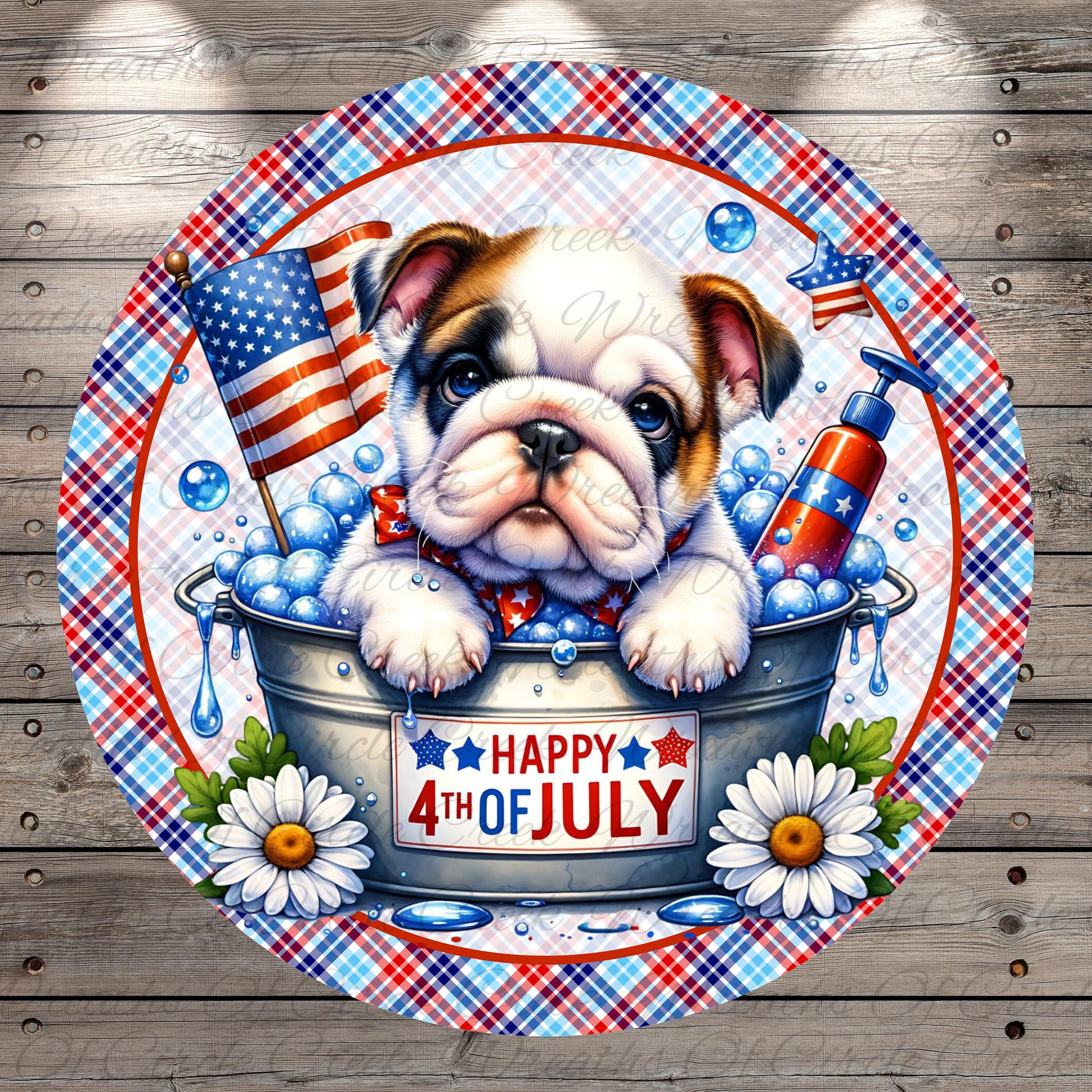 A bulldog is sitting in a bucket filled with bubbles, surrounded by American flags, daisies, and a "Happy 4th of July" sign.
