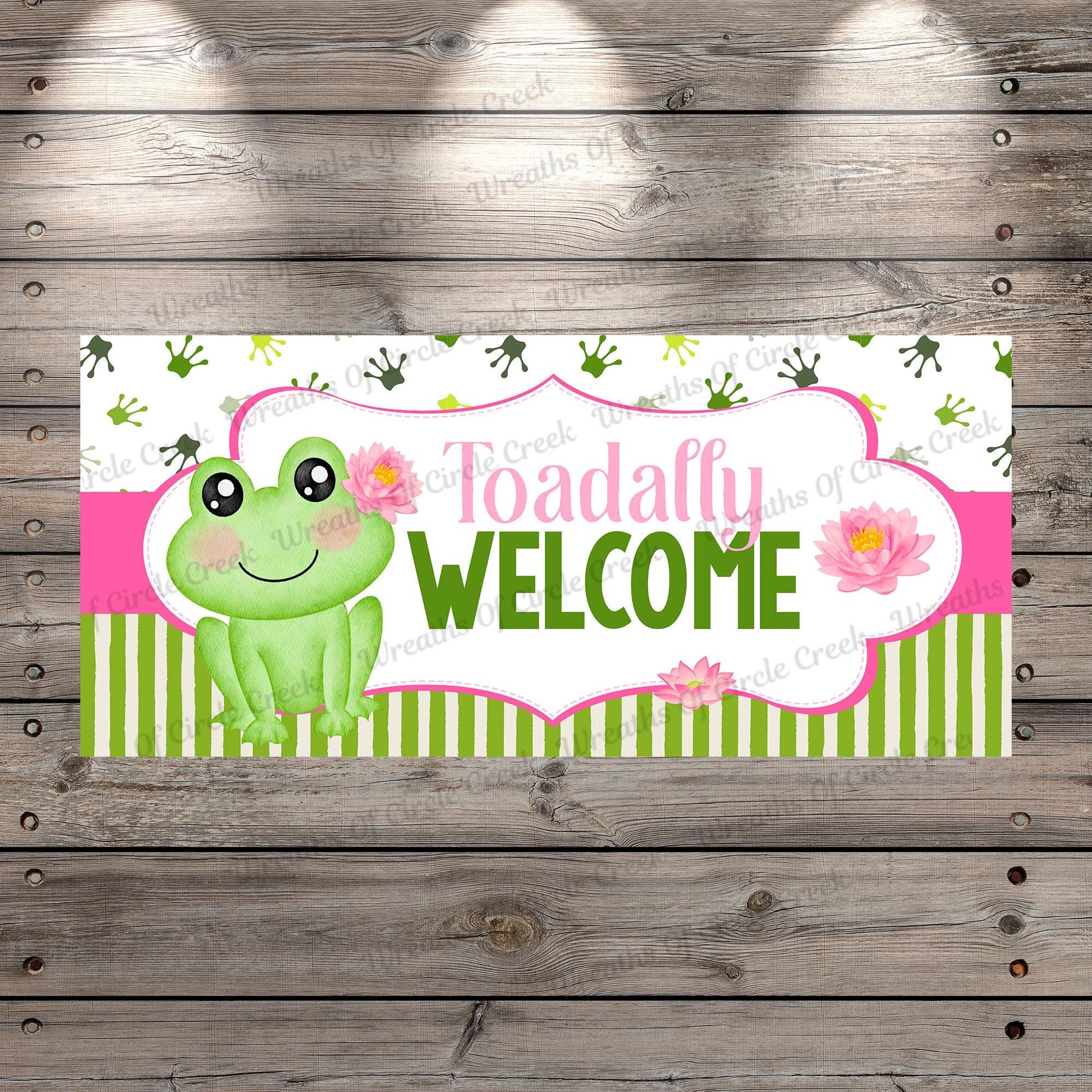 a welcome sign with a frog sitting on top of it