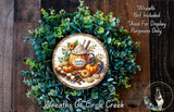 a wreath with a pumpkin and other fall-themed items, including a pumpkin-shaped mug and a pumpkin. The wreath is surrounded by a lush green plant and has a wooden frame. The text "Wreath Not Included * Used For Display Purposes Only" is displayed above the wreath, and the text "Wreaths Of Circle Creek" is written below the wreath.