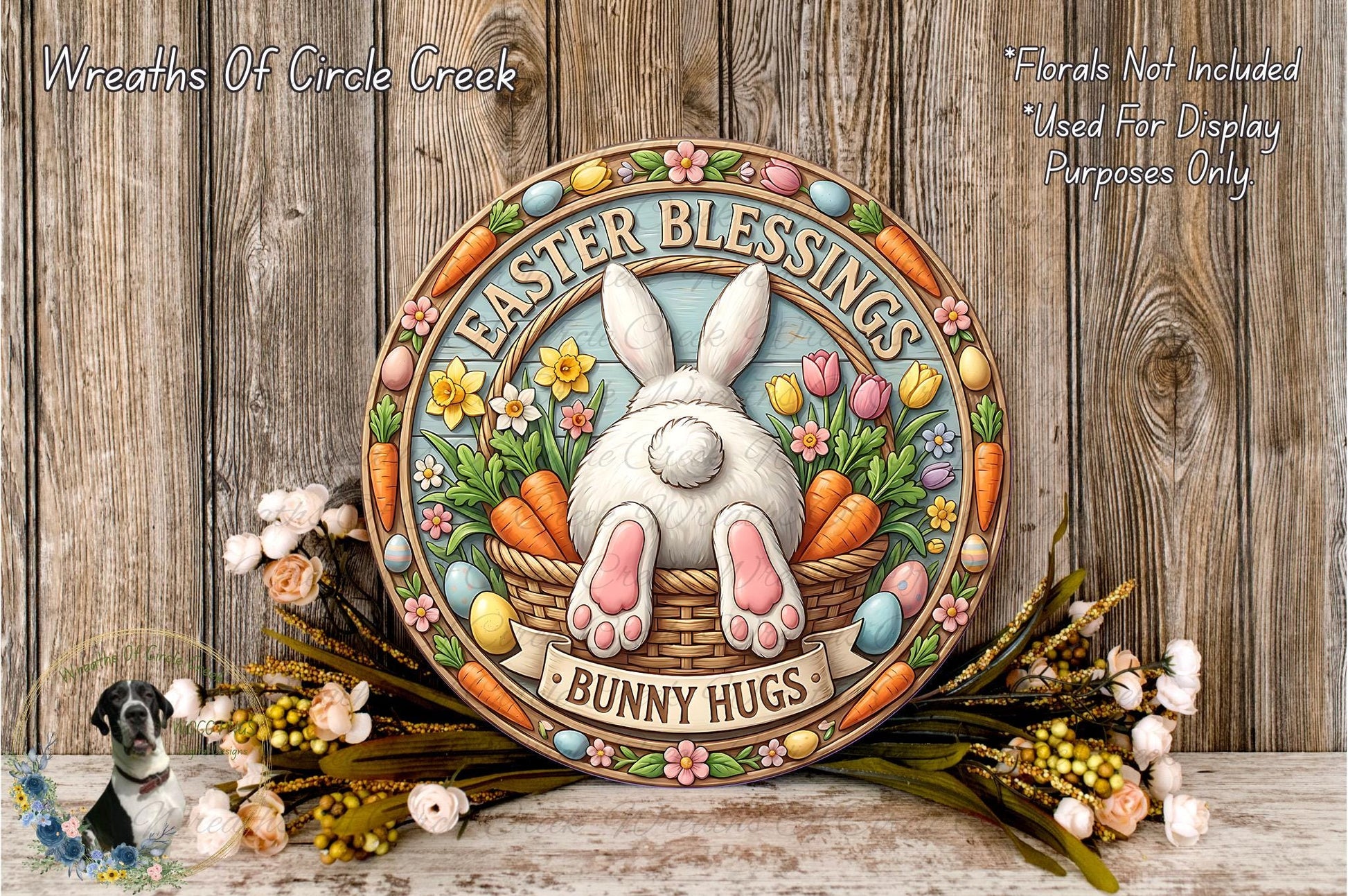 a decorative Easter-themed sign with a bunny sitting in a basket filled with flowers and carrots. The sign has a floral border and the text "Easter Blessings Bunny Hugs" written on it. The sign is surrounded by a wreath of flowers and a bunch of carrots, creating a festive and cheerful atmosphere.