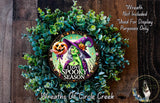 a wreath with a picture of two witches on it