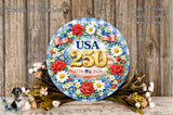 A decorative wreath with the text "USA 250" and "1776-2026" displayed on it, surrounded by flowers and greenery.