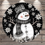 A whimsical snowman with a hat and scarf, surrounded by snowflakes and flowers, is depicted in the image.