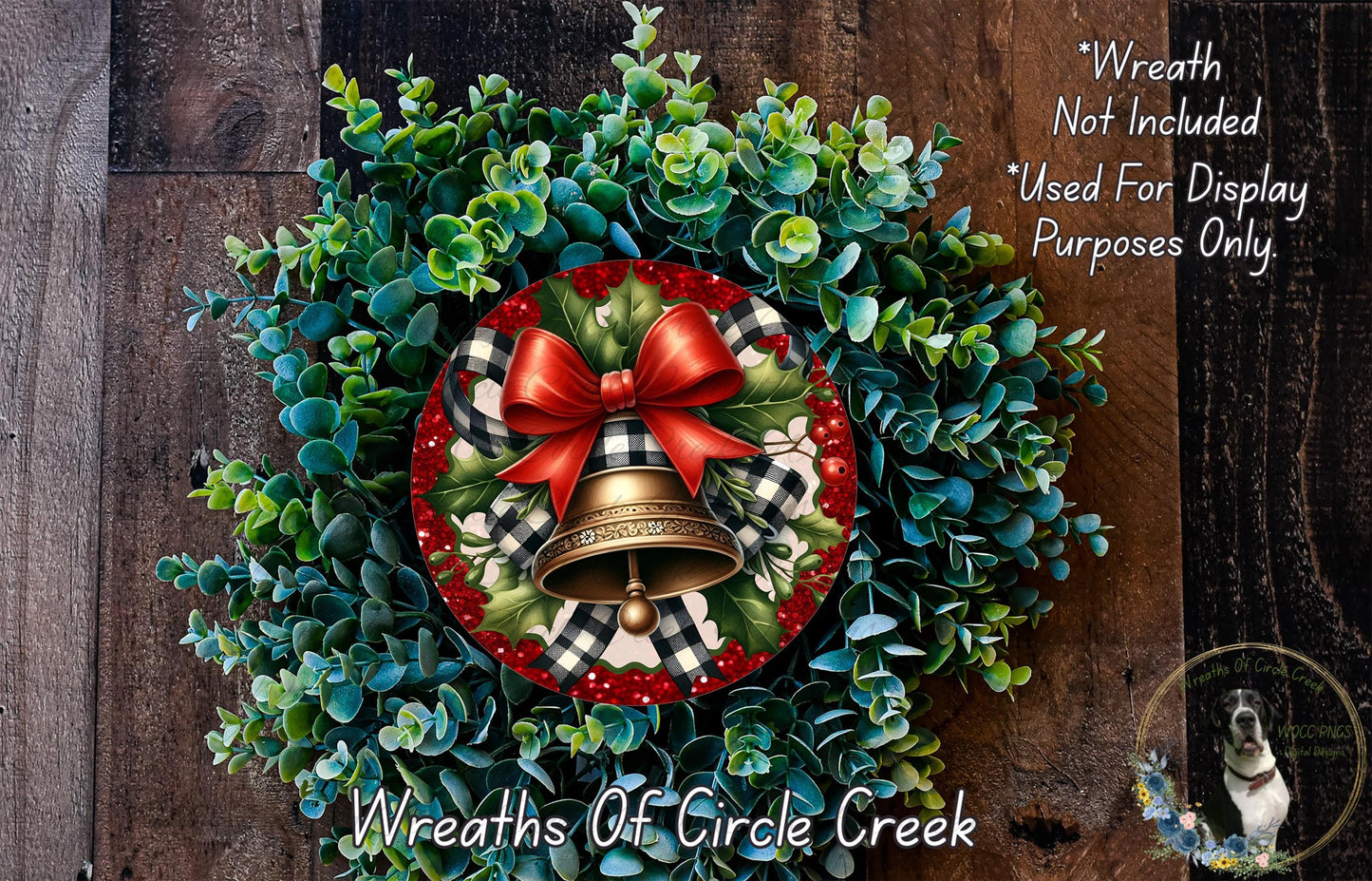 A wreath made of green and red foliage, with a bell and a red bow, is displayed on a wooden surface.