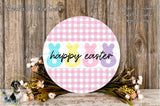 a round sign with the text "happyp Easter" displayed on it, surrounded by a floral arrangement and a wooden background.