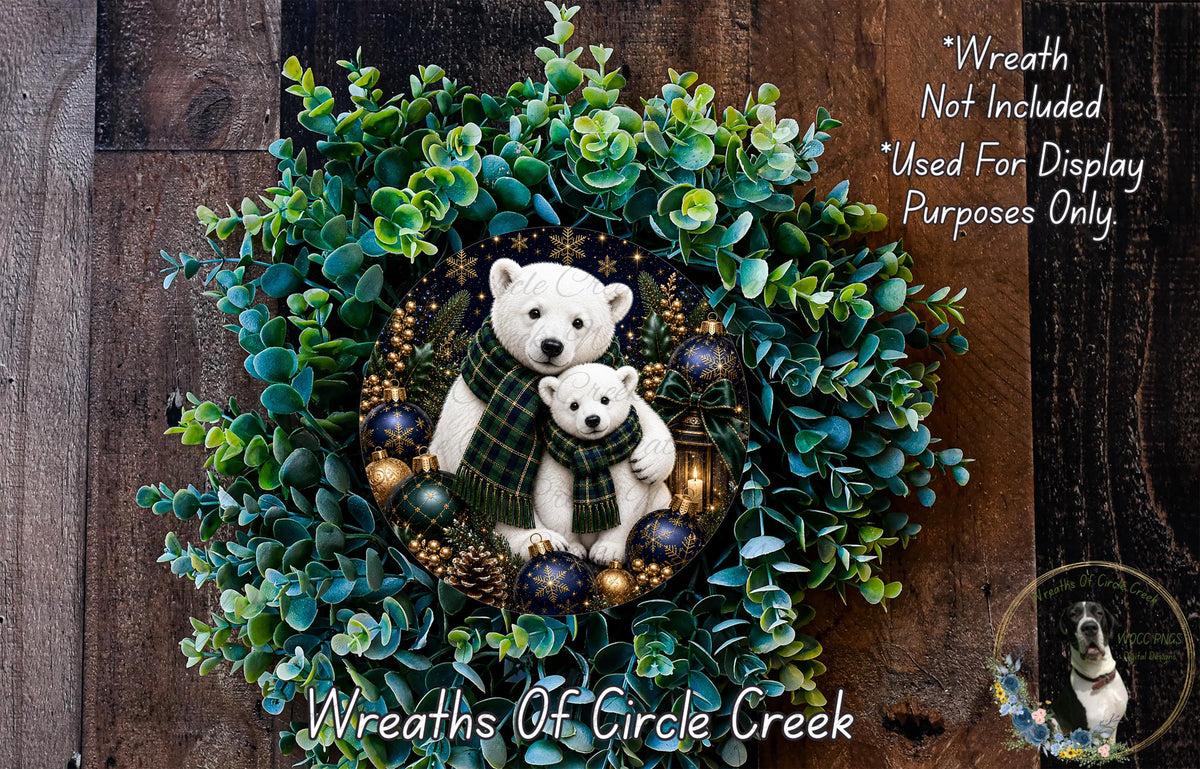 A wreath made of green leaves and pine cones, featuring two white bears wearing plaid scarves. The wreath is displayed on a wooden surface.
