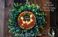 A wreath made of evergreen branches and red poinsettias, with a circular arrangement of lit candles and a "Merry Christmas" message.