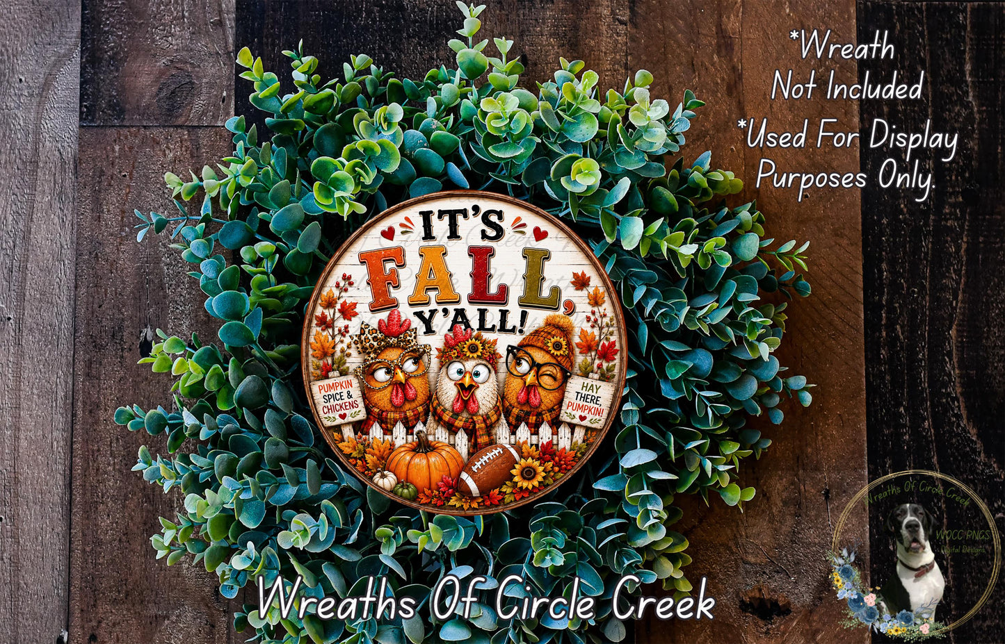 A wreath made of green leaves and featuring a circular sign with the text "It's Fall Y'all" surrounded by three cartoon owls and a dog.