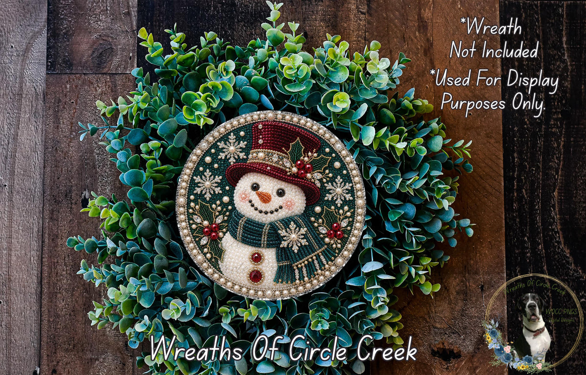 A wreath featuring a snowman made of beads and greenery, with a caption stating that it is not included in a display and is used for purposes only.