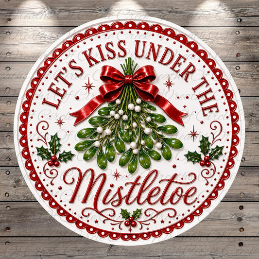 A decorative circular sign with the text "Let's Kiss Under The Mistletoe" and a decorative ribbon, surrounded by a festive design with holly leaves, berries, and pine cones.
