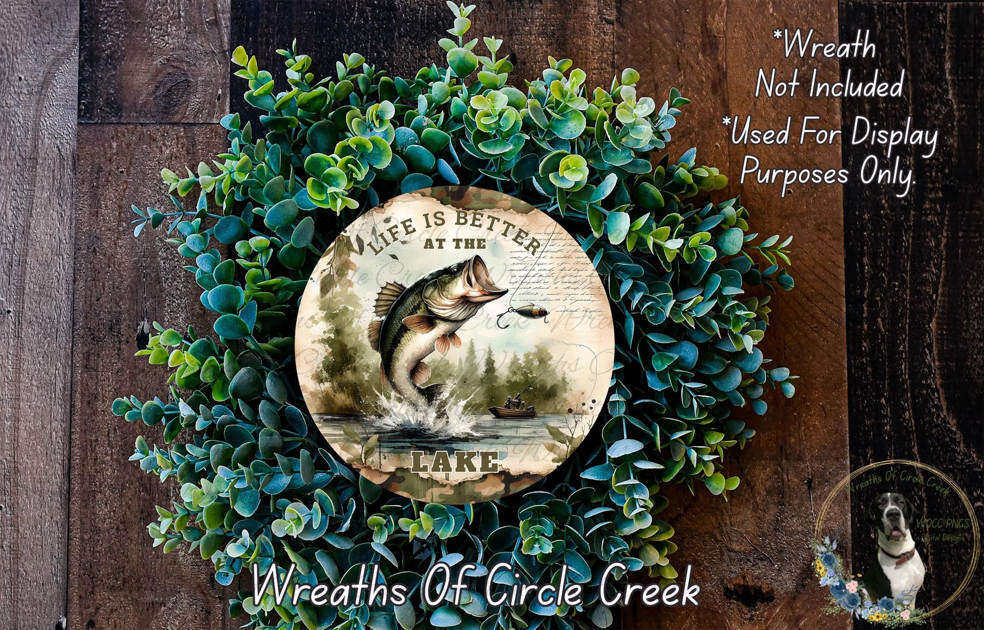 A wreath made of green foliage and a circular plate with a fish illustration, placed on a wooden surface.