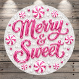 A circular arrangement of pink and white candy pieces, with the text "Merry & Sweet" prominently displayed in the center.